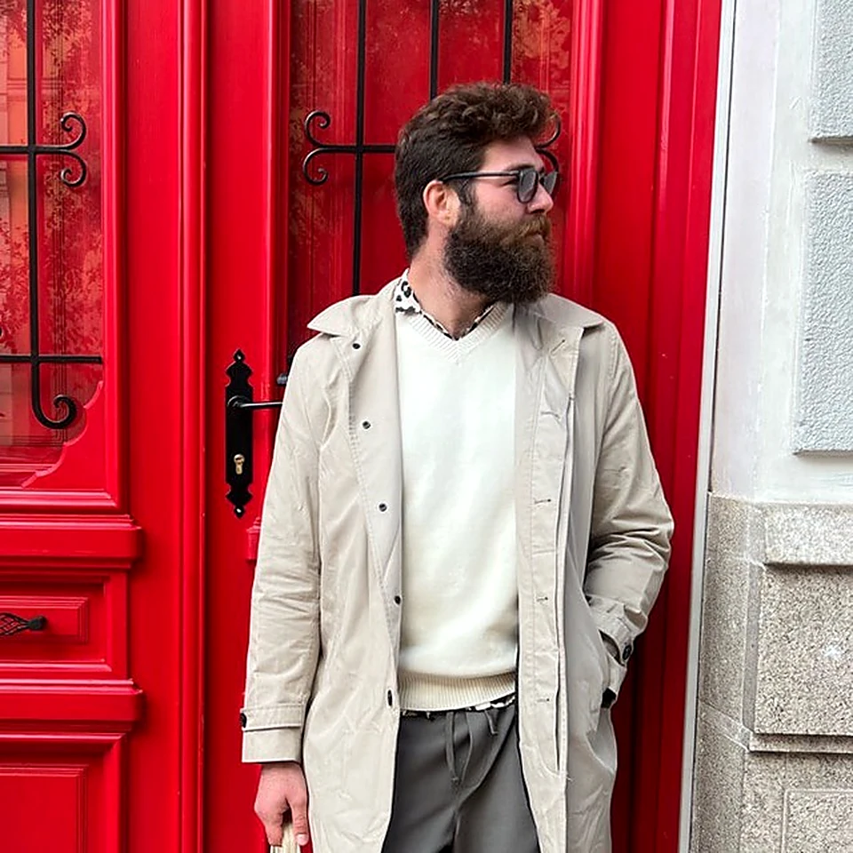 Mikhail Shal standing by a red doorway